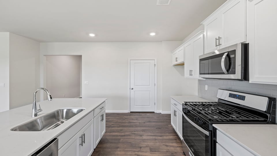 Kitchen with island and quartz countertops.