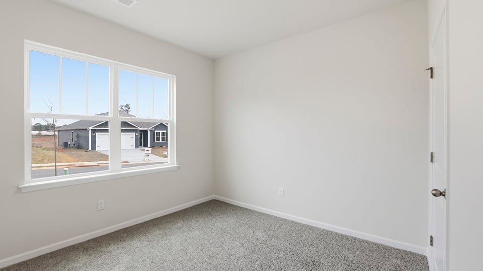 Bedroom with carpet and window.