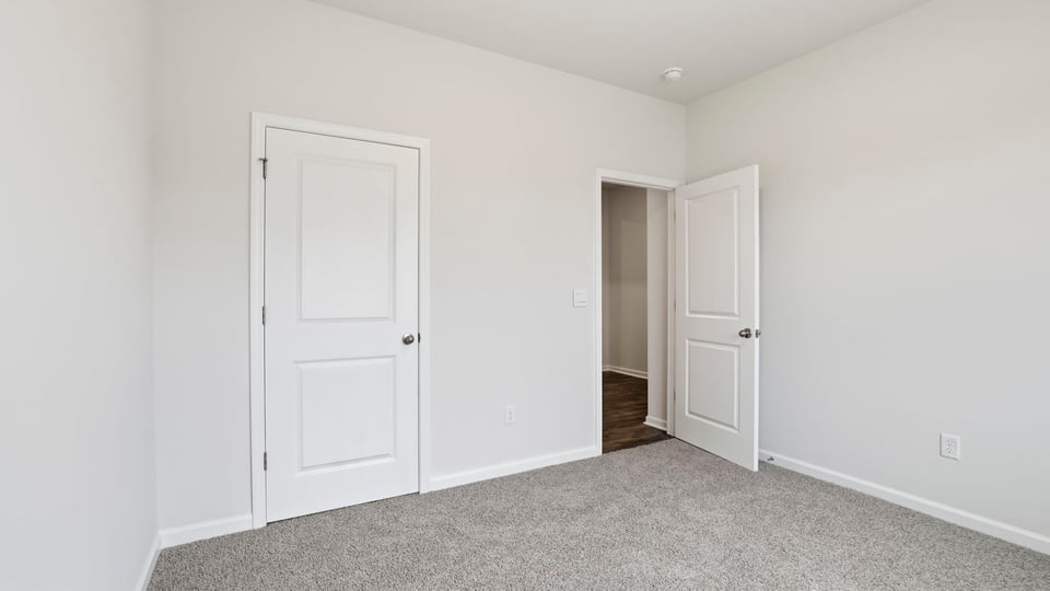 Bedroom with carpet and window.