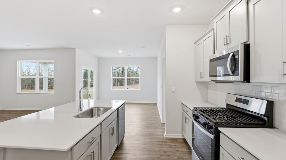 Kitchen and island with white cabinets.