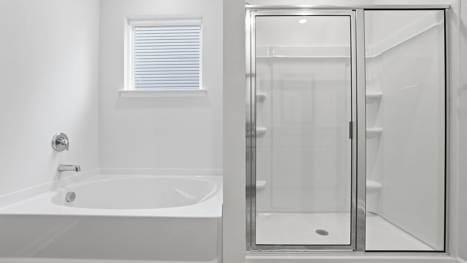 Primary bathroom with garden tub and walk-in shower.