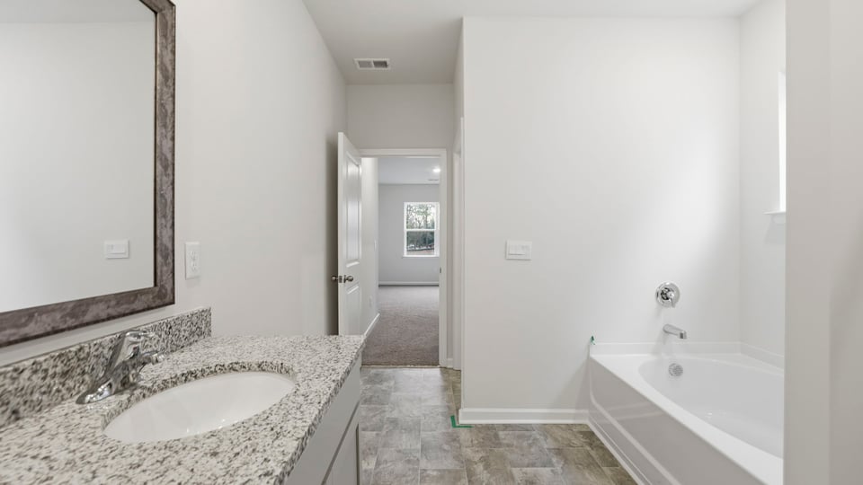 Primary bathroom with dual sink vanity.