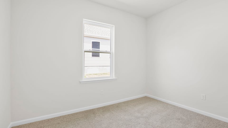 Bedroom with carpet and windows.