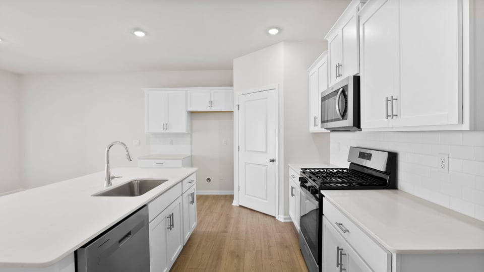 Kitchen with island and cabinets.