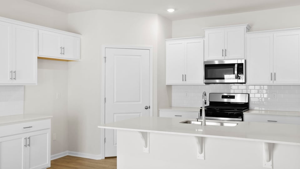 Kitchen with island and cabinets.