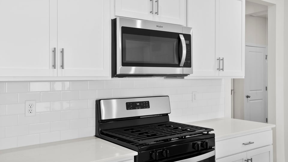 Kitchen with island and cabinets.