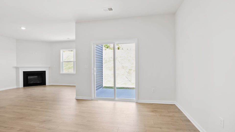 Living room with fireplace and windows.