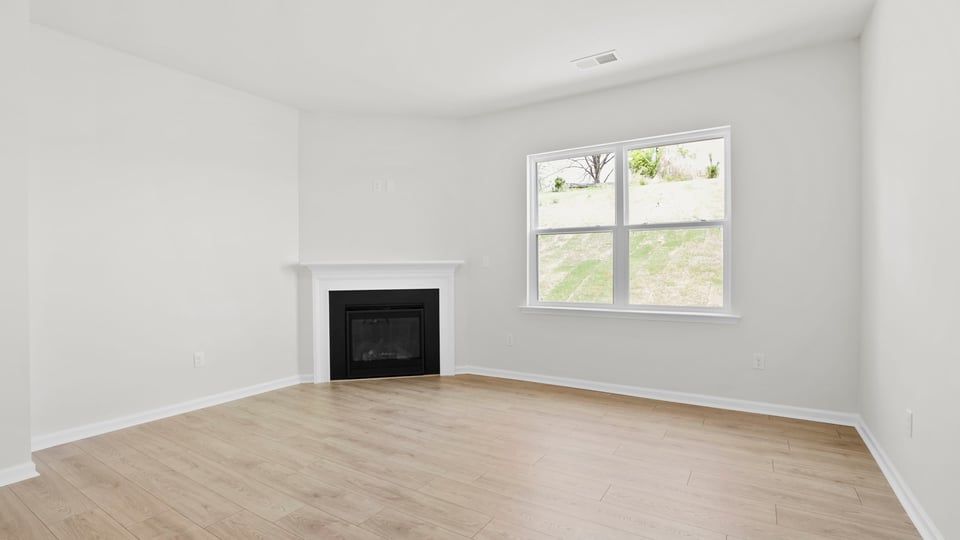 Living room with fireplace and windows.