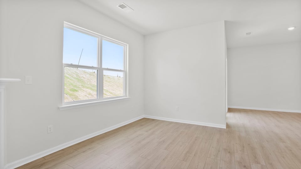 Living room with fireplace and windows.