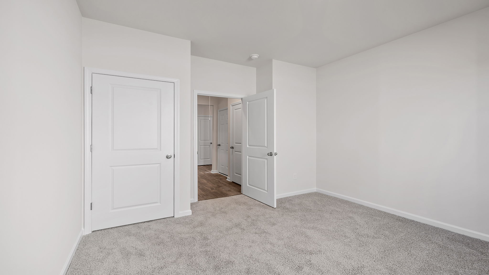 Bedroom with carpet with window.