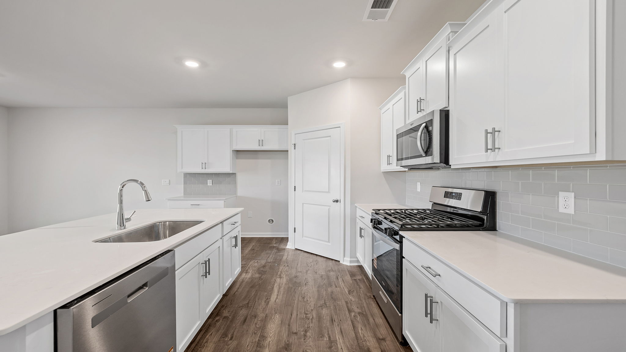 Kitchen with island and cabinets.