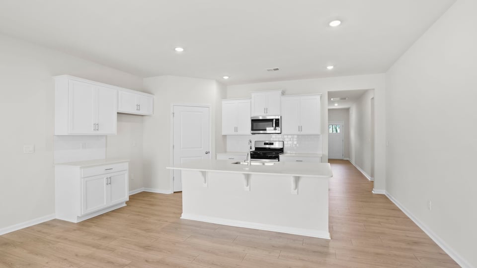 Kitchen with island and cabinets.