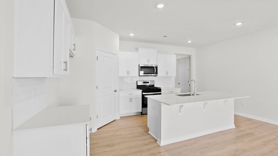 Kitchen with island and cabinets.