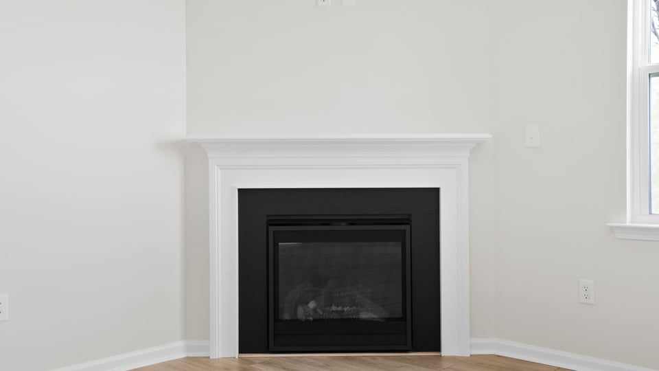Living room with fireplace and windows.