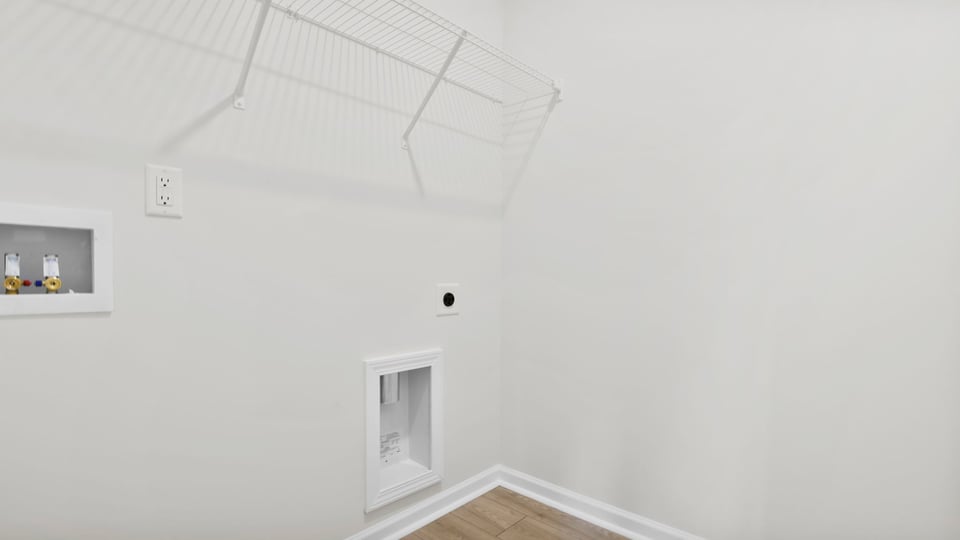 Laundry room with shelf.