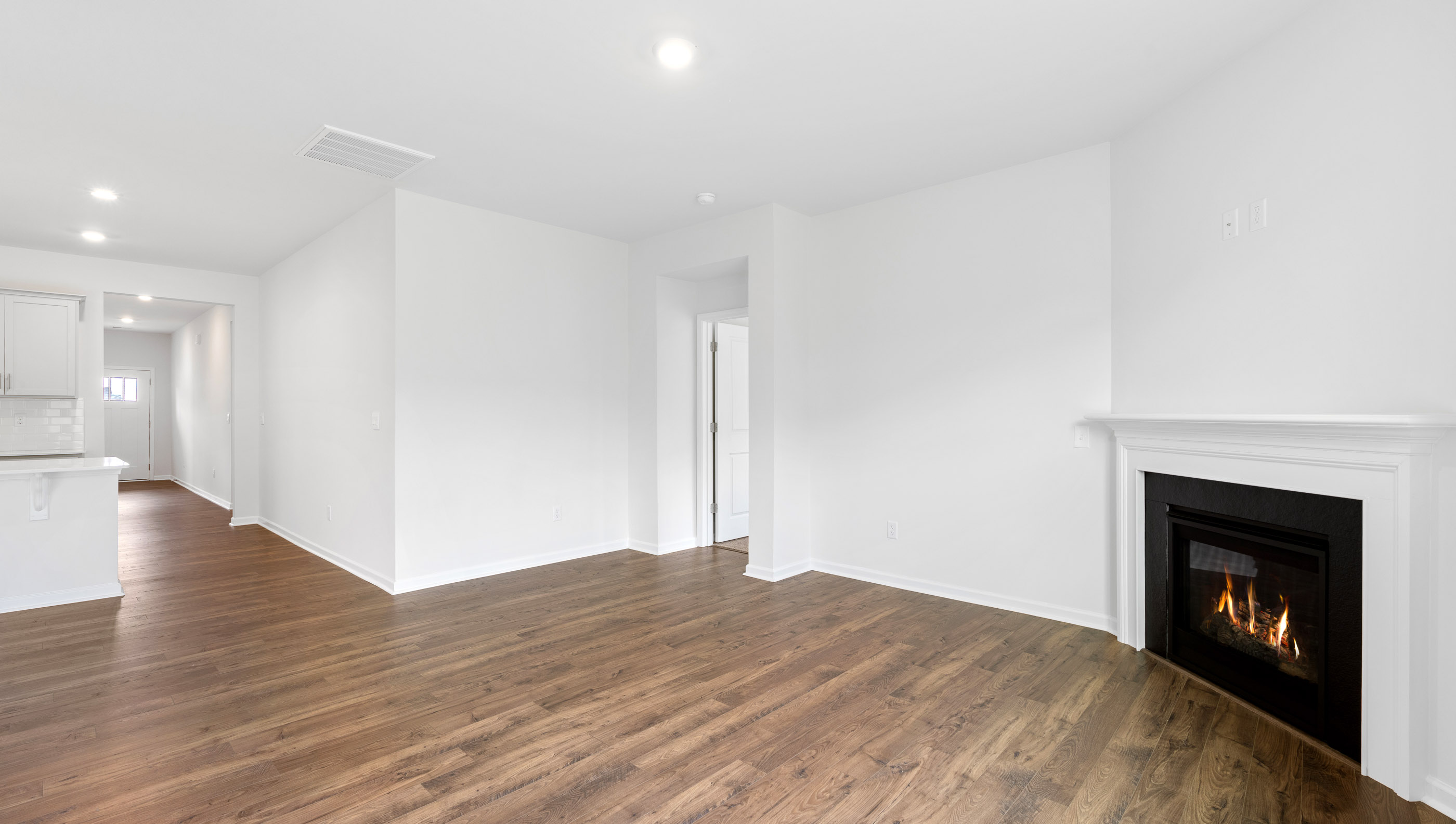 View of living area and hallway to the entrance.