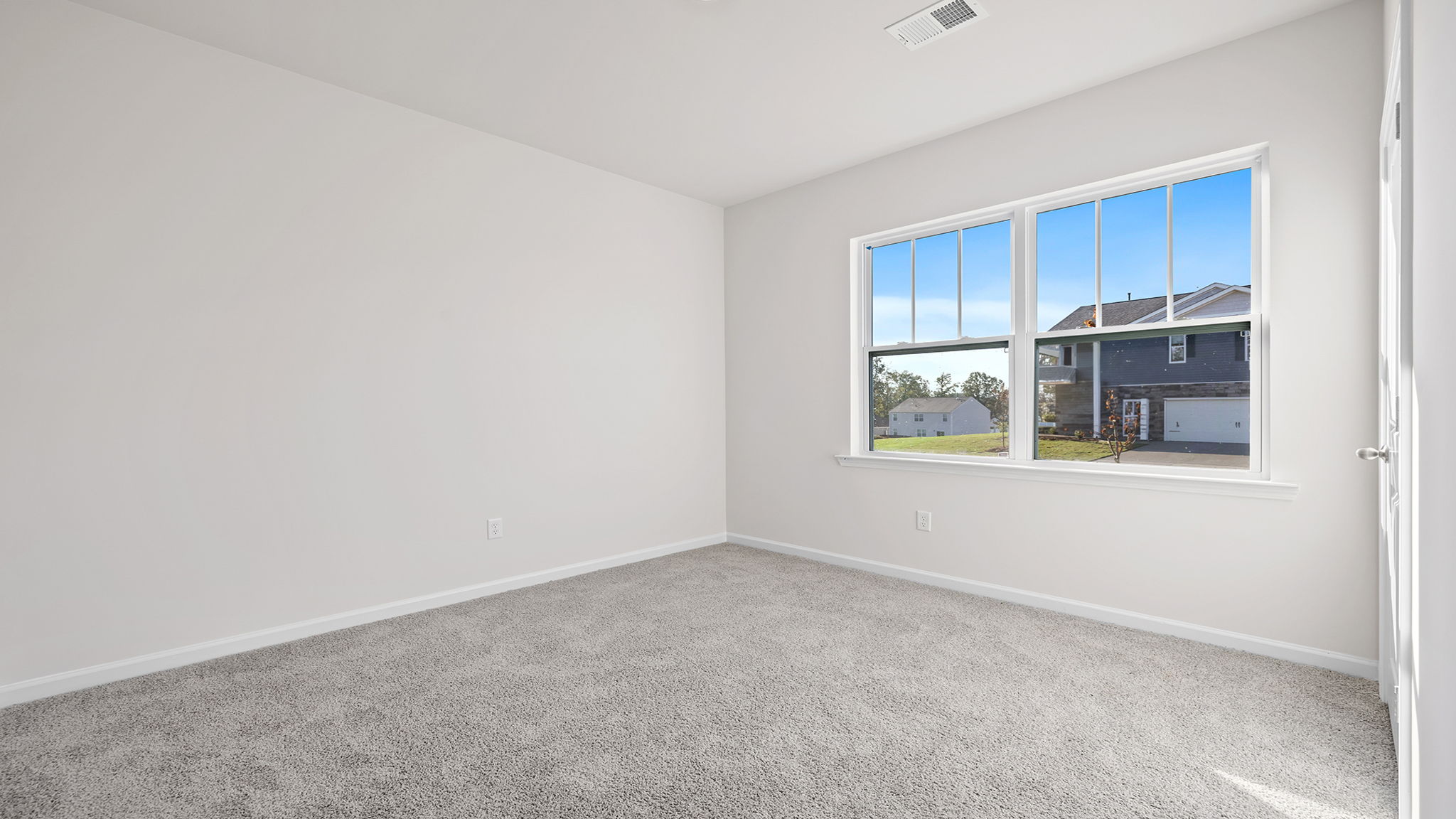 Bedroom 3 with large window and carpet.