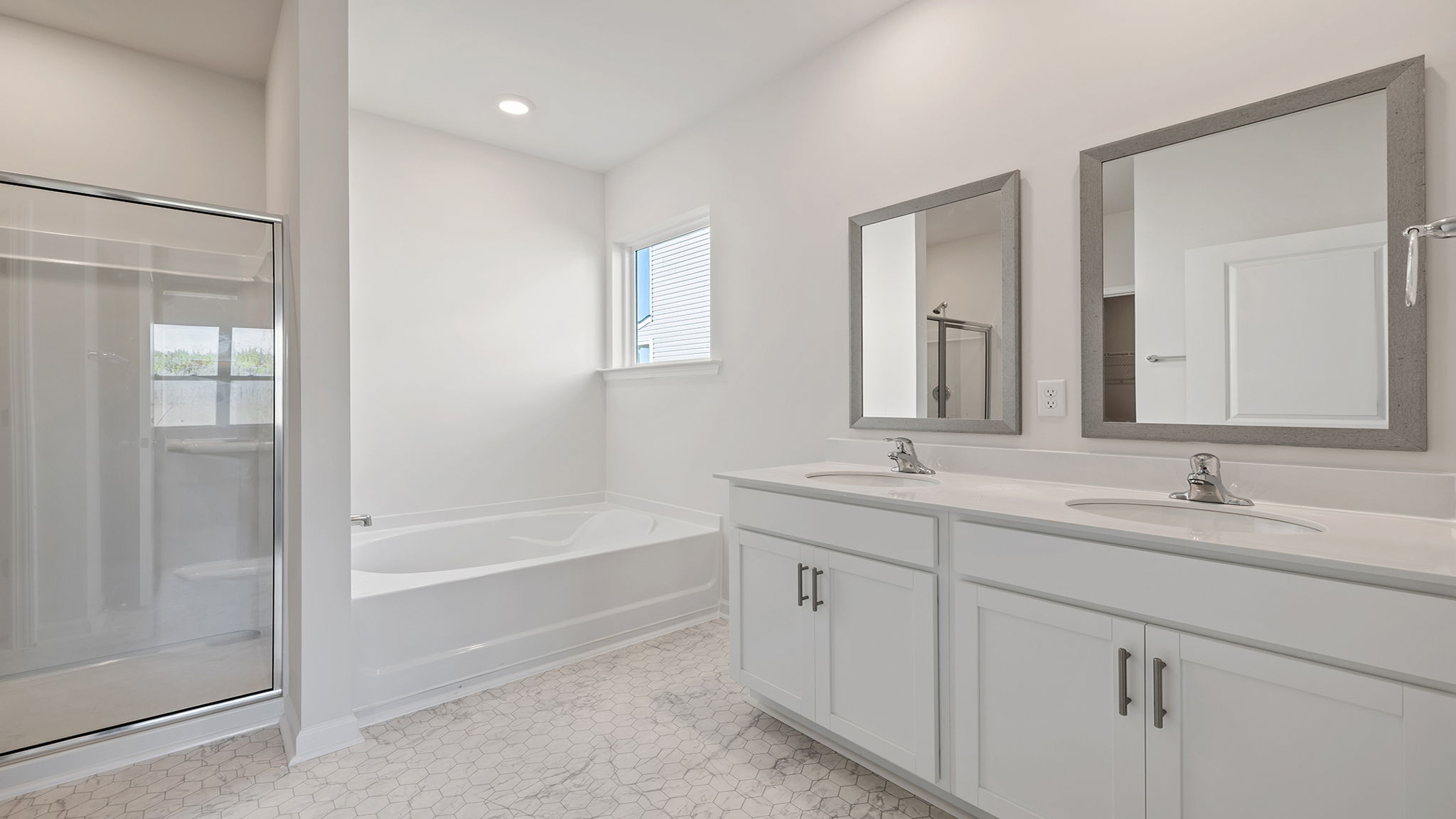 Primary bathroom with dual sink vanity.