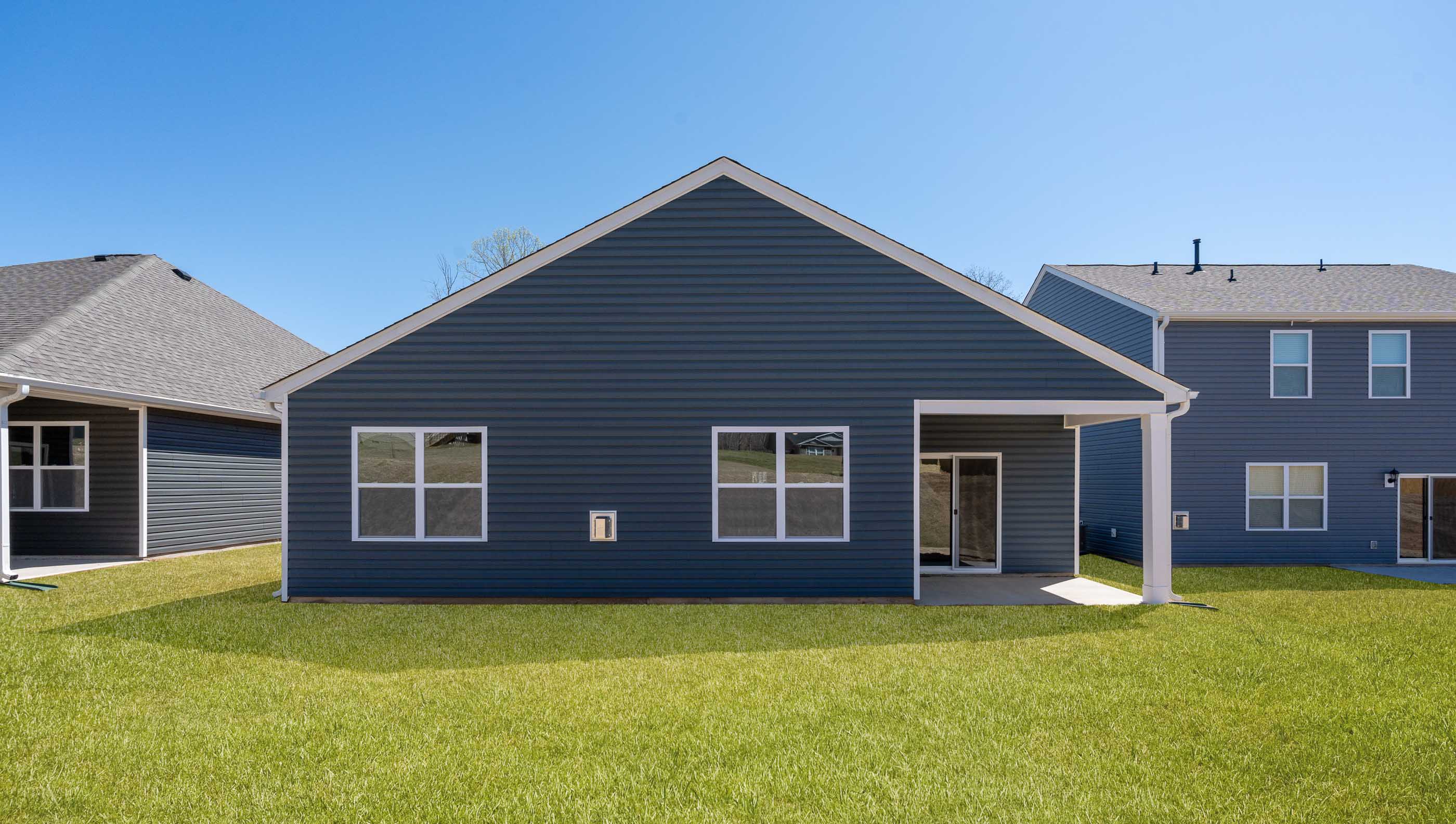 Back exterior with large backyard.