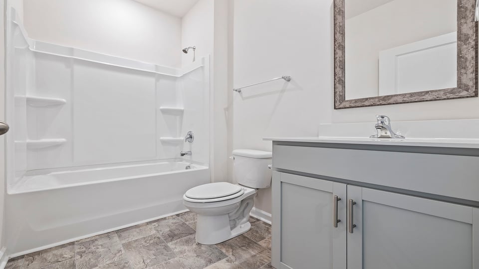 Hall bath with vanity and combination shower / tub.