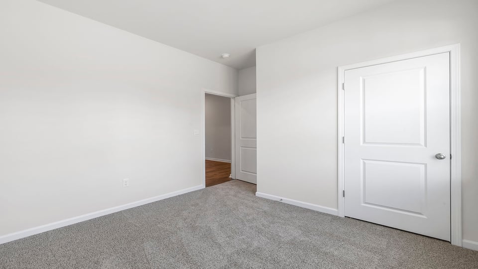 Bedroom with window and carpet.