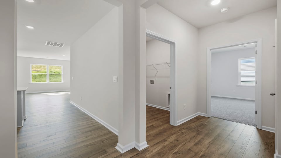 Hallway view of 3rd bedroom and laundry placement.