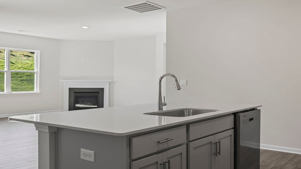 Kitchen island with sink and granite countertops.