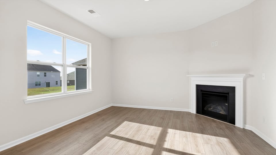 Living area with windows and fireplace.