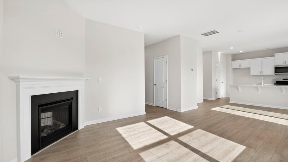Living area with windows and fireplace.