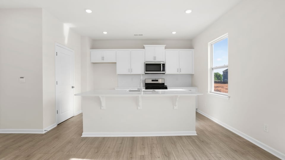 Kitchen with island and cabinets.