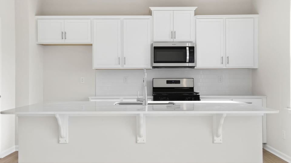 Kitchen with island and cabinets.