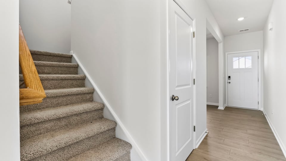 Stairs to second level with carpet.