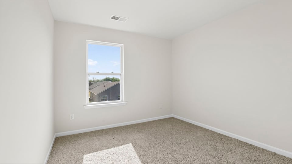 Bedroom with carpet and windows.