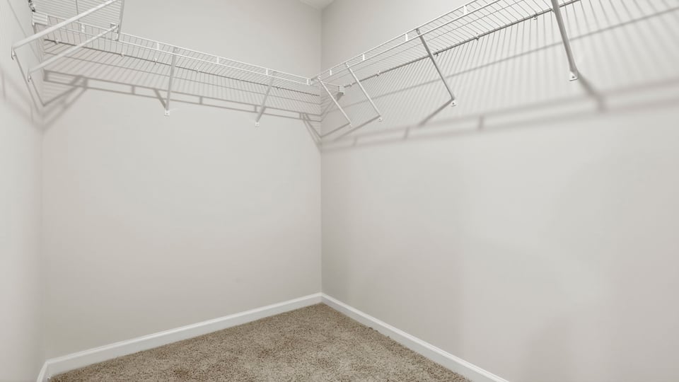 Primary closet with shelf.