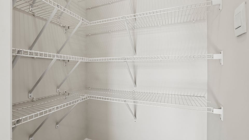 Primary closet with shelf.