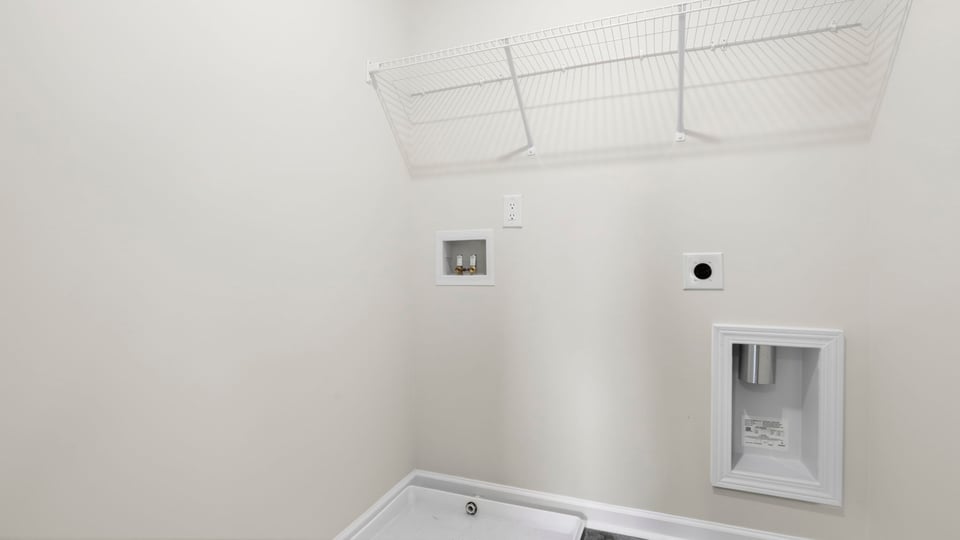 Laundry room with shelf.