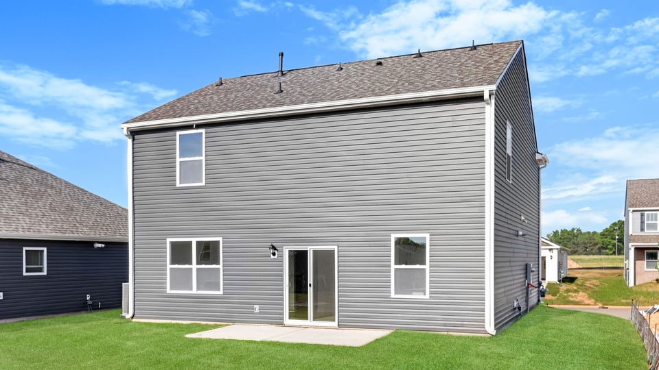 Back exterior with large backyard.