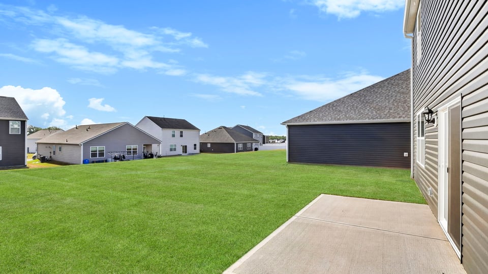 Back exterior with large backyard.