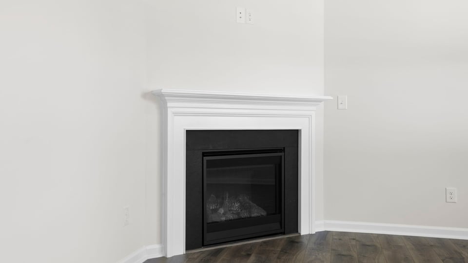 Living room with fireplace and windows.