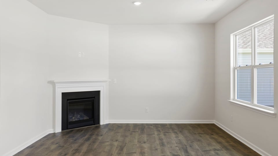 Living room with fireplace and windows.