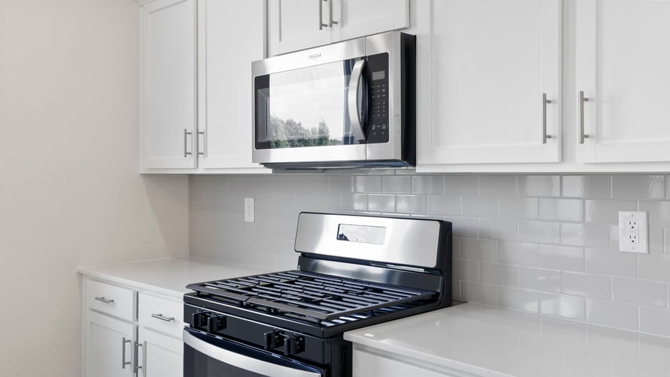 Kitchen with island and cabinets.