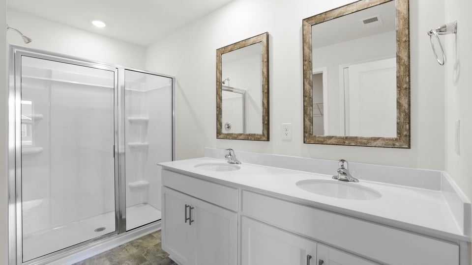 Primary bathroom with double vanity sinks.