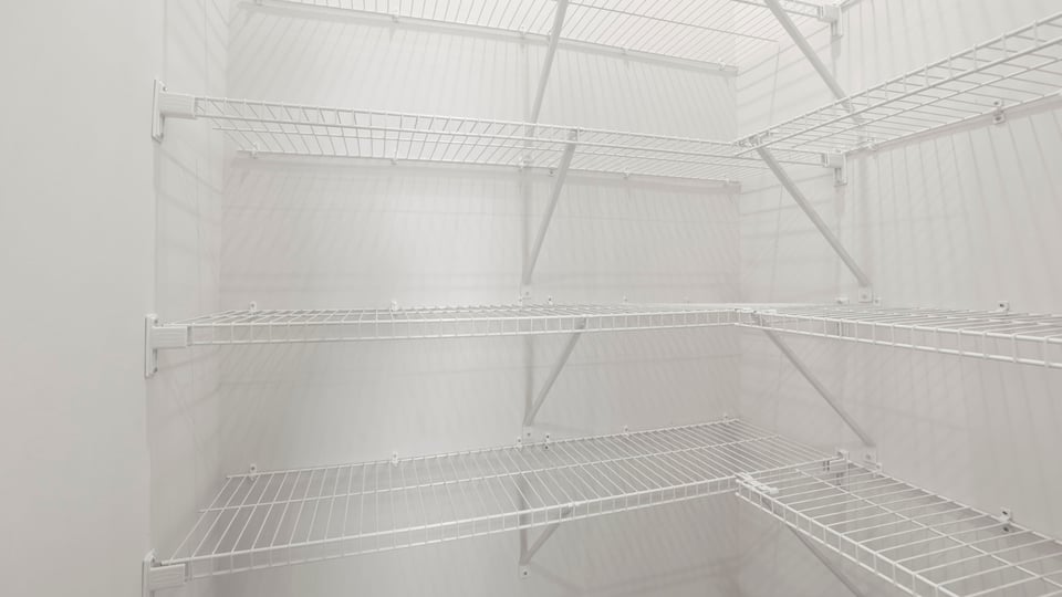 Primary closet with shelf.