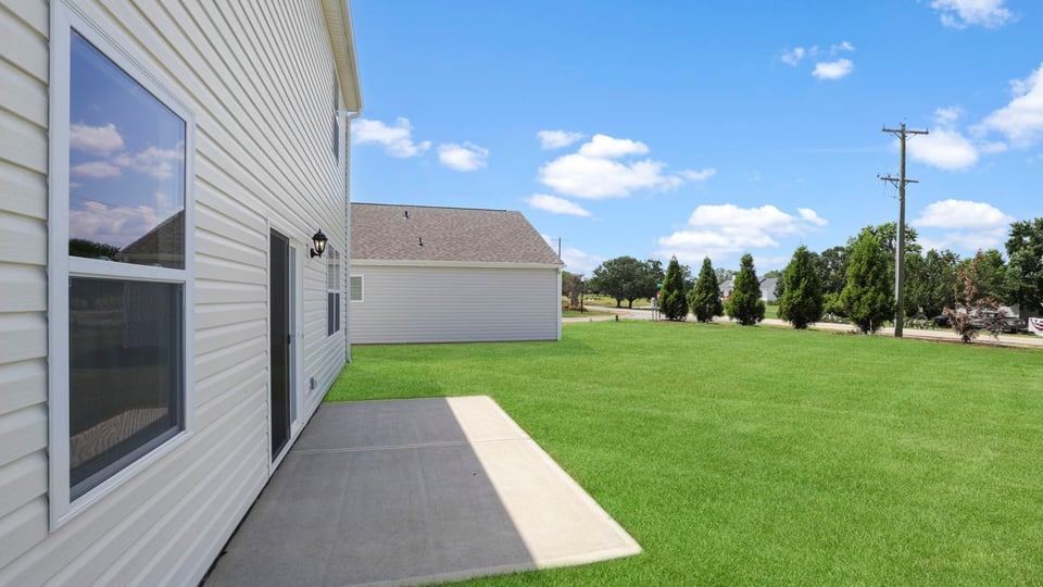 Back exterior with large backyard.