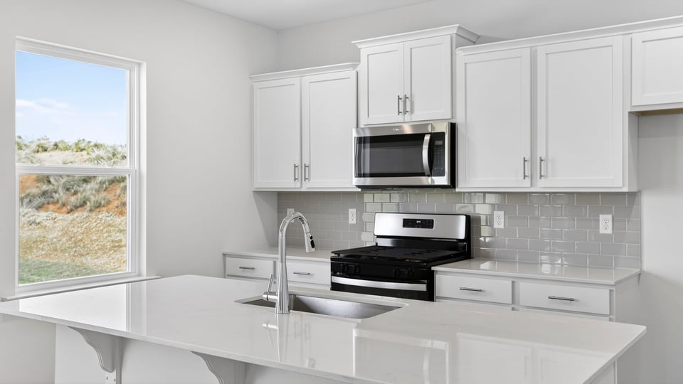 Kitchen with island and cabinets.