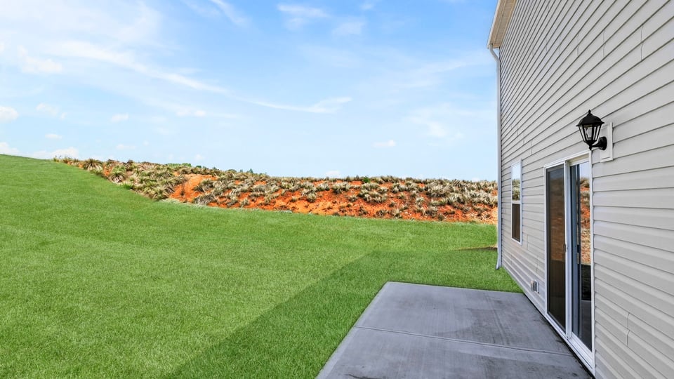 Back exterior with large backyard.