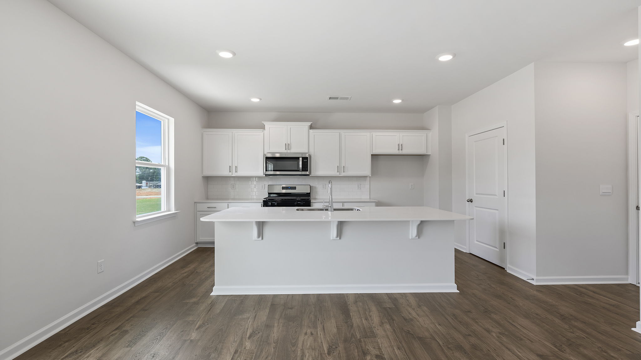 Kitchen with island and quartz countertops.
