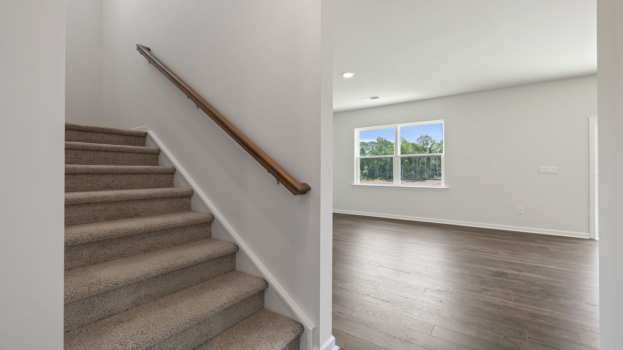 Stairwell off the living room to the upper level.