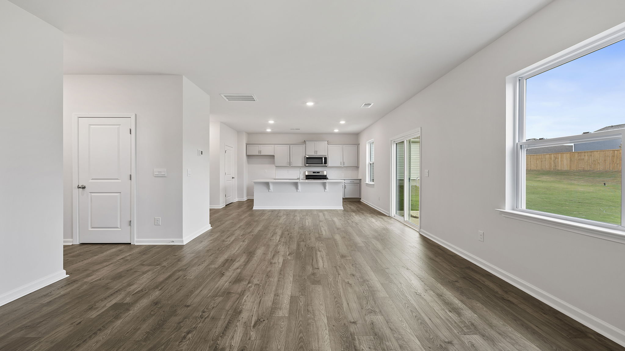 View of open floor plan with combination family and dining areas.