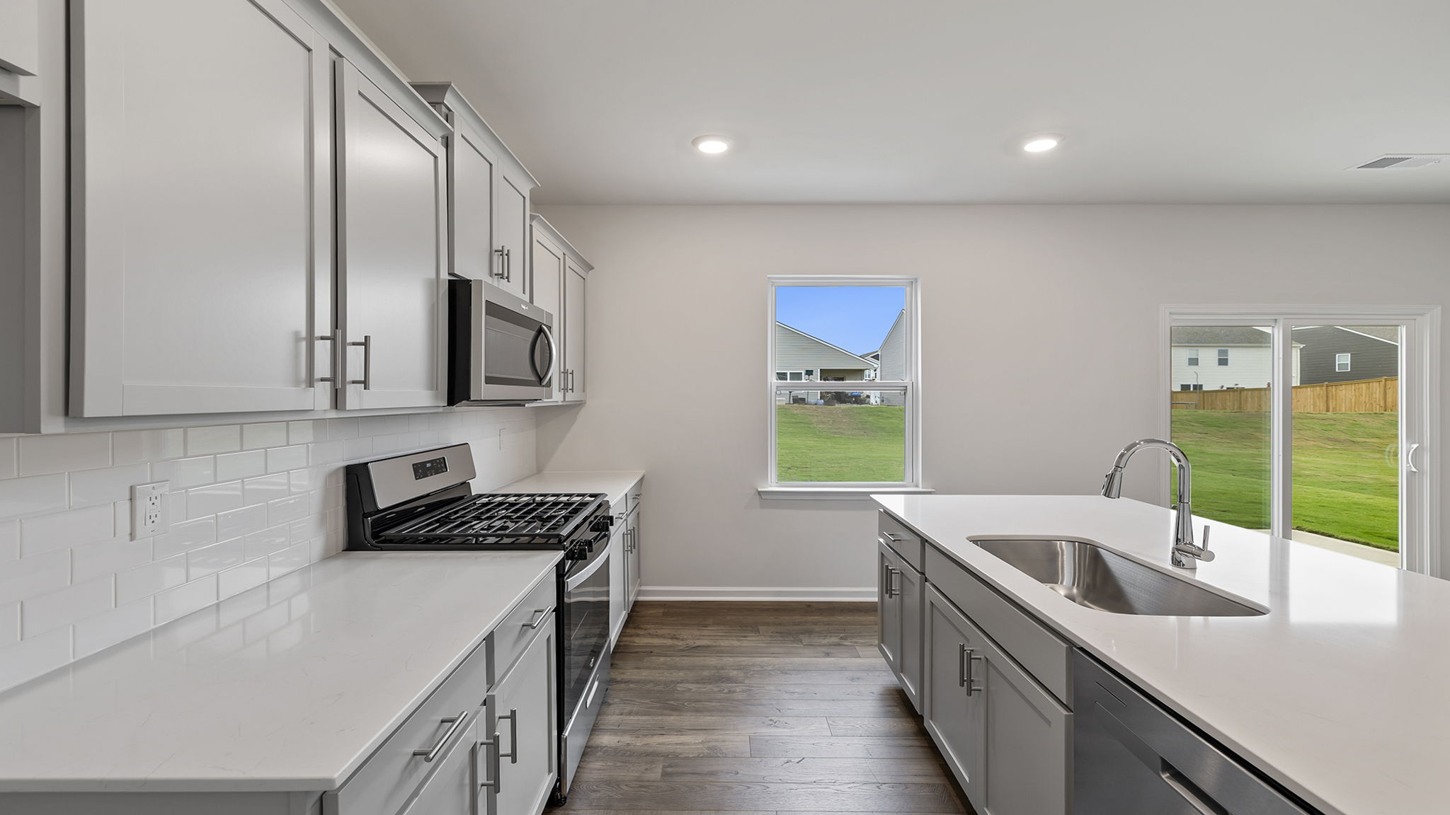 View of patio door and kitchen with island.